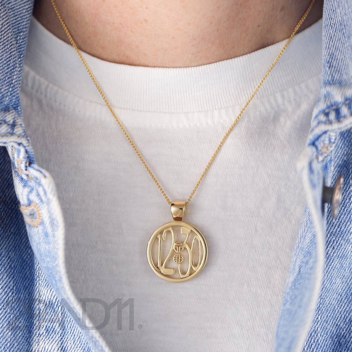 The Ashe is our monogram pendant inspired by our beloved monograms that grace all the thing we love and use daily. The numbers 12 and 30 are stretched vertically to the edges of the pendant.&nbsp; The numbers 12 and 30 are separated by a colon which is represented by our logo. Down the vertical side of the pendant the chapter name 'Mark' is inscribed on the monogram pendant.