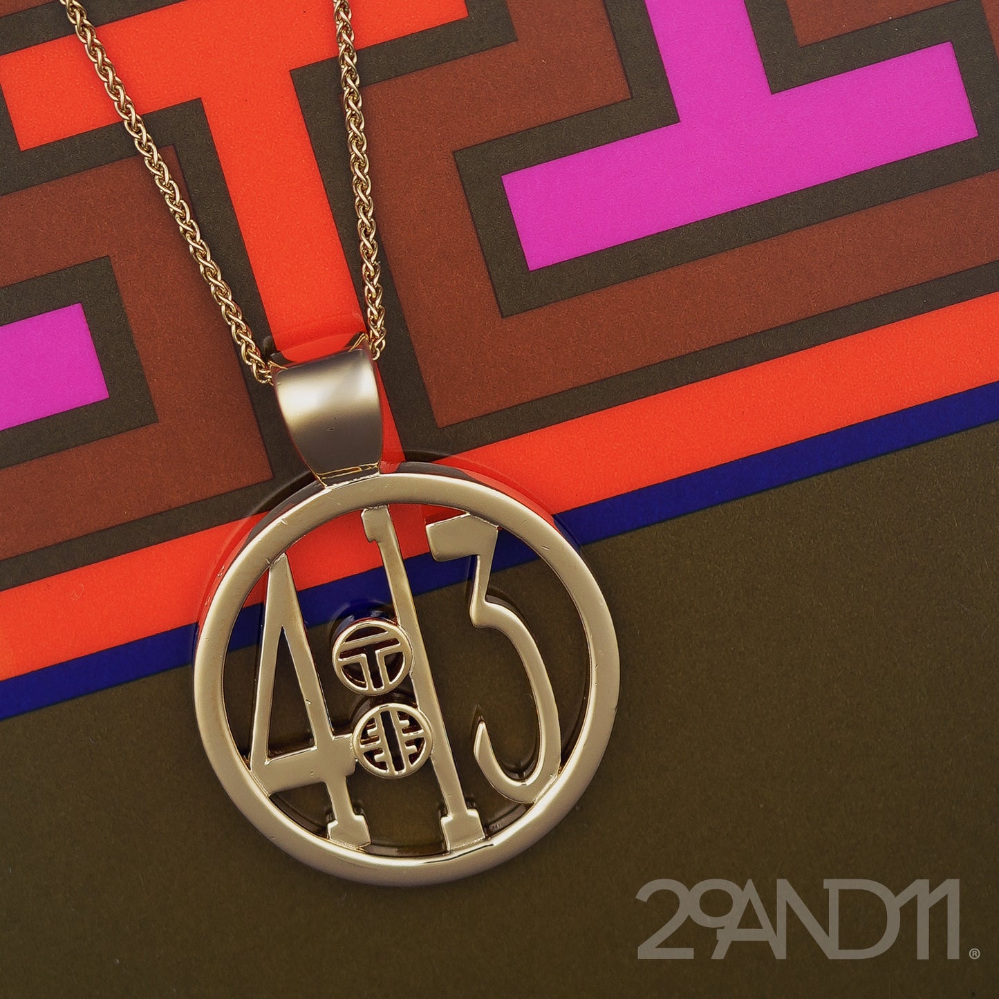 The Ashe is our monogram pendant inspired by our beloved monograms that grace all the thing we love and use daily. The numbers 4 and 13 are stretched vertically to the edges of the pendant. The numbers 4 and 13 are separated by a colon which is represented by our logo. Down the vertical side of the pendant the chapter name 'Philippians' is inscribed on the monogram pendant.