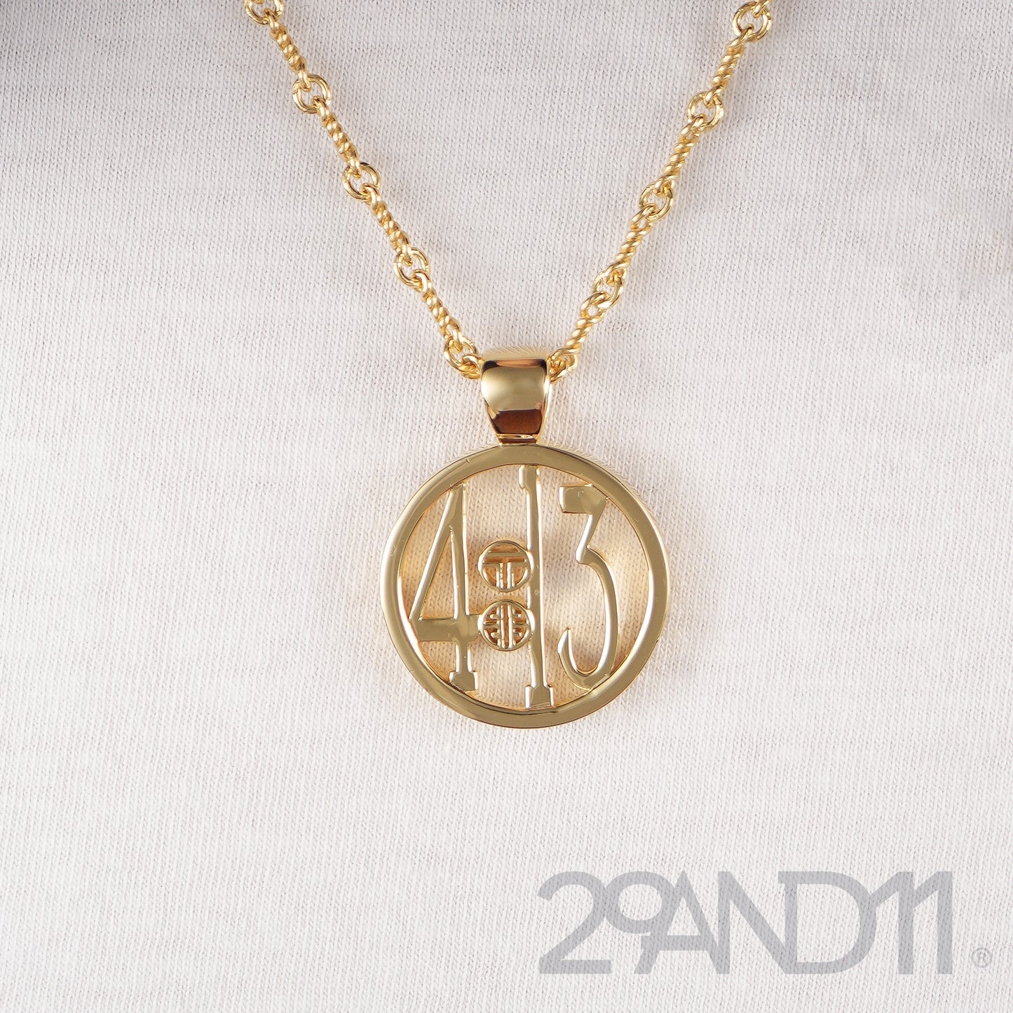 The Ashe is our monogram pendant inspired by our beloved monograms that grace all the thing we love and use daily. The numbers 4 and 13 are stretched vertically to the edges of the pendant. The numbers 4 and 13 are separated by a colon which is represented by our logo. Down the vertical side of the pendant the chapter name 'Philippians' is inscribed on the monogram pendant.