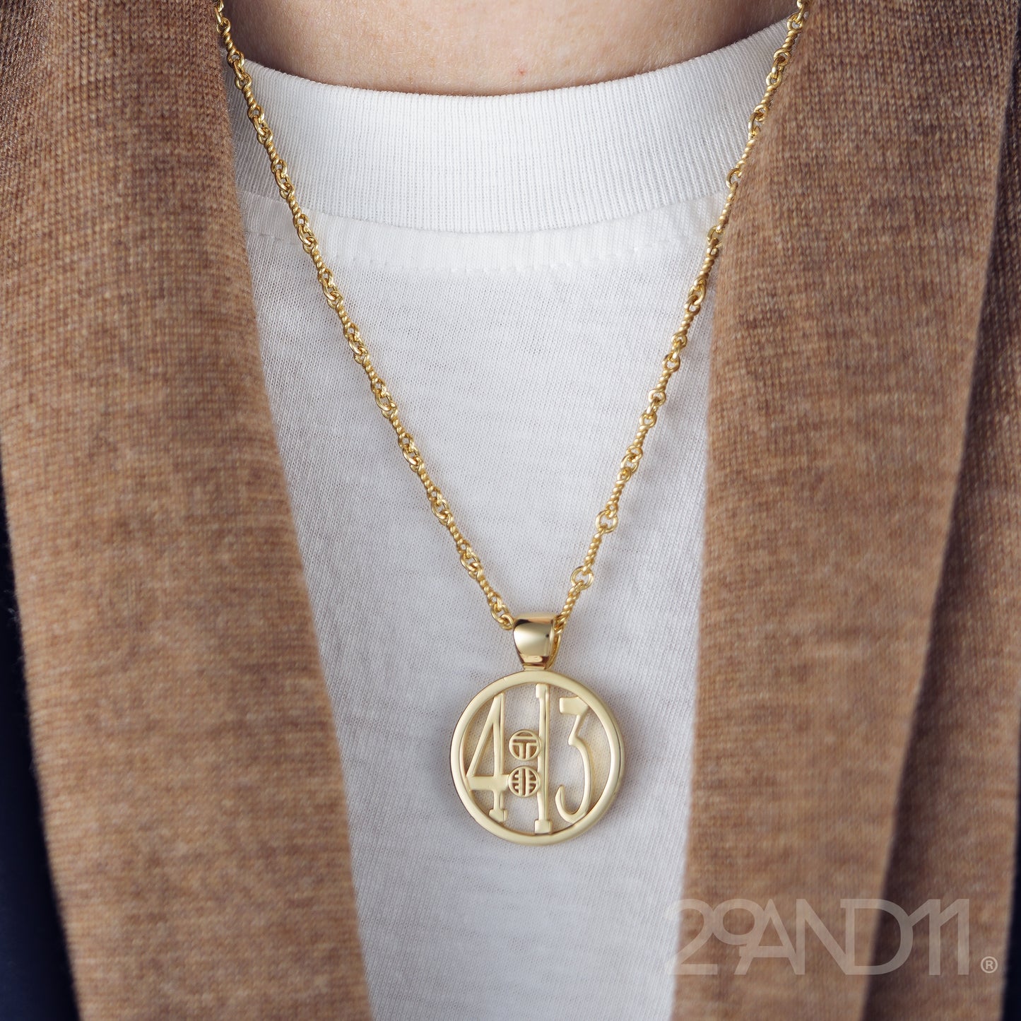 The Ashe is our monogram pendant inspired by our beloved monograms that grace all the thing we love and use daily. The numbers 4 and 13 are stretched vertically to the edges of the pendant. The numbers 4 and 13 are separated by a colon which is represented by our logo. Down the vertical side of the pendant the chapter name 'Philippians' is inscribed on the monogram pendant.