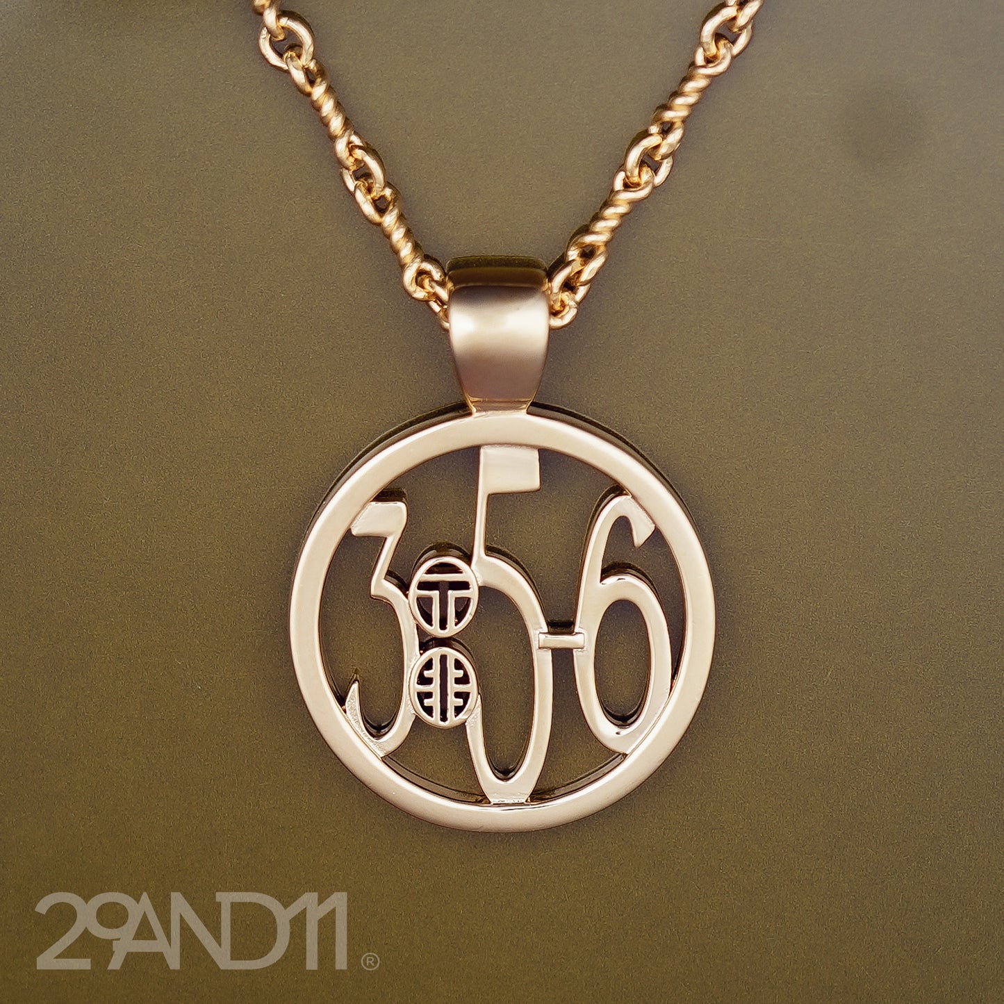 The Ashe is our monogram pendant inspired by our beloved monograms that grace all the thing we love and use daily. The numbers 3, 5, and 6 are stretched vertically to the edges of the pendant. The numbers 3, 5, and 6 are separated by a colon which is represented by our logo.Down the vertical side of the pendant the chapter name Proverbs is inscribed on the monogram pendant.  Model is wearing the pendant on a 18" Rolo chain.