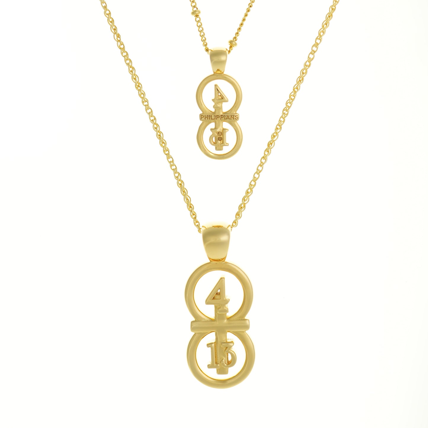 Gold small and large pendants displayed on a white background with our 14k gold filled satellite chain paired with the small pendant and our 14k gold filled Rolo chain paired with the larger pendant.  Our 29 and 11® pendant has the numbers 4 and 13 intertwined with the cross to represent Philippians 4:13 with the chapter word "Philippians" inscribed on the back.