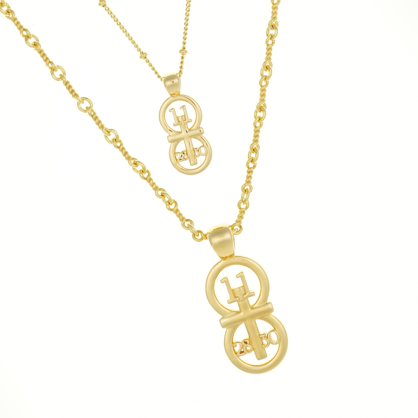 Gold small and large pendants displayed on a white background with the satellite chain paired with the small pendant and our rolo chain paired with the larger pendant.  The RIYAN 29 and 11® pendant has the numbers 11, 28, and 30 intertwined with the cross to represent Matthew 11:28-30 with the chapter word "Matthew" inscribed on the back.